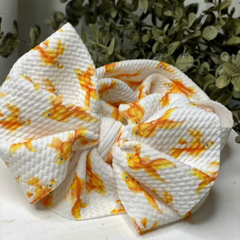 Goldfish bow headband for newborn up to 4 years ago old approximately.